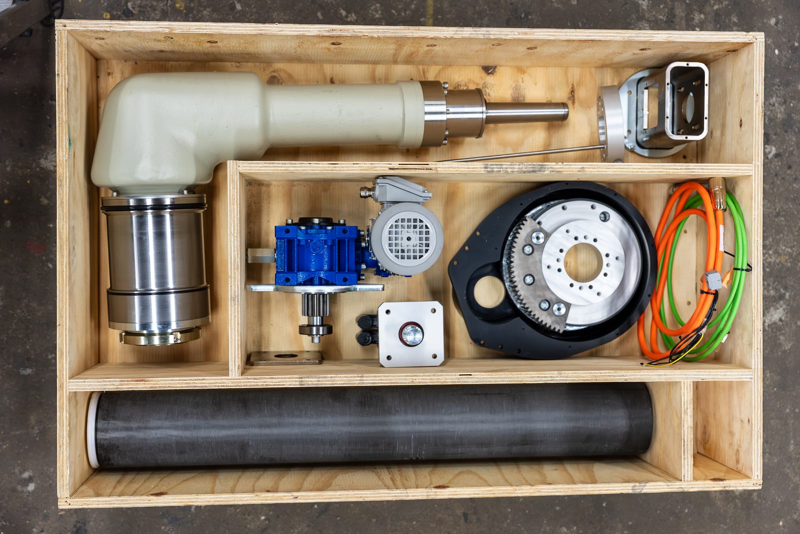 A complete RotorSwing rotor system packed in its wooden transport crate: the rotor, the drive unit, the gearbox, the slewing ring and the cabling